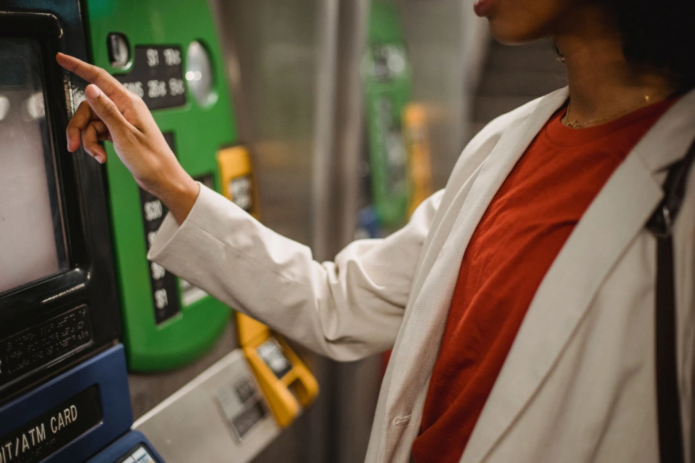 A customer using a self-service kiosk POS machine to complete a transaction, highlighting how automated point-of-sale systems operate.